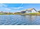 Scenic view of houses along the waterfront with lush green lawns and blue water at 75 Inlets Blvd # 75, Nokomis, FL 34275