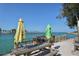 Scenic water view with picnic tables and umbrellas on a sunny day, perfect for outdoor enjoyment at 75 Inlets Blvd # 75, Nokomis, FL 34275