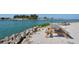 Picturesque waterfront view with picnic tables and a small boat adding to the scenery at 75 Inlets Blvd # 75, Nokomis, FL 34275