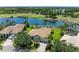 Aerial view of the home featuring a private pool, lush landscaping, and a stunning waterfront location at 7574 Camden Harbour Dr, Bradenton, FL 34212
