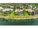 Aerial view of a home with a screened-in pool and well-maintained landscaping on a waterfront property at 7574 Camden Harbour Dr, Bradenton, FL 34212