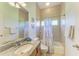 Well-lit bathroom featuring granite countertops, a vanity mirror, a shower and tub combo at 7574 Camden Harbour Dr, Bradenton, FL 34212