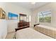 This bedroom is furnished with two beds, a dresser with a mirror, and a wall-mounted TV at 7574 Camden Harbour Dr, Bradenton, FL 34212