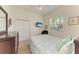 Bright bedroom with a ceiling fan, closet, and a window that offers natural light at 7574 Camden Harbour Dr, Bradenton, FL 34212