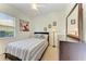 Cozy bedroom with striped bedding, a ceiling fan, and a window letting in natural light at 7574 Camden Harbour Dr, Bradenton, FL 34212