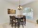 Formal dining room with decorative lighting, arched windows, and seating for six offers an elegant space at 7574 Camden Harbour Dr, Bradenton, FL 34212