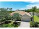 Charming single-story home featuring a barrel tile roof and lush landscaping at 7574 Camden Harbour Dr, Bradenton, FL 34212