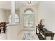 Inviting foyer with decorative glass doors, soaring ceilings, and marble flooring at 7574 Camden Harbour Dr, Bradenton, FL 34212