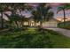 Charming single-story home with a well-manicured lawn, mature landscaping, and a brick-paved driveway at 7574 Camden Harbour Dr, Bradenton, FL 34212