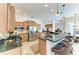 Bright kitchen features custom cabinets, stainless steel appliances, and a breakfast bar with stylish pendant lighting at 7574 Camden Harbour Dr, Bradenton, FL 34212