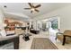Spacious open concept living area with view into the kitchen and the screened in patio and pool at 7574 Camden Harbour Dr, Bradenton, FL 34212
