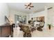 Bright living room with tile floors, ceiling fan, and view of the outdoor patio through sliding glass doors at 7574 Camden Harbour Dr, Bradenton, FL 34212