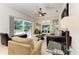 A sun-filled living room features tile floors and sliding glass doors that lead to a covered lanai with pool views at 7574 Camden Harbour Dr, Bradenton, FL 34212
