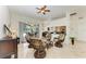 Open concept living area with rattan furniture in a light-filled space with a view to the pool and patio at 7574 Camden Harbour Dr, Bradenton, FL 34212
