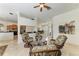 Bright living room with tile floors offers a view of the kitchen and formal dining room through the open floor plan at 7574 Camden Harbour Dr, Bradenton, FL 34212