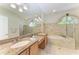 Main bathroom features a soaking tub, dual sinks, and decorative windows for a luxurious spa-like experience at 7574 Camden Harbour Dr, Bradenton, FL 34212