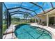 Refreshing pool and spa in a screened lanai with relaxing lounge chairs and stunning water views at 7574 Camden Harbour Dr, Bradenton, FL 34212
