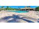 Resort-style pool with a spacious patterned deck, surrounded by lush tropical landscaping and comfortable lounge chairs at 7574 Camden Harbour Dr, Bradenton, FL 34212
