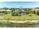 Beautiful outdoor space with screened pool, mature landscaping, and serene water view at 7574 Camden Harbour Dr, Bradenton, FL 34212