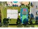 The recreational area includes a sand volleyball court and game courts with painted lines and bright colors at 7574 Camden Harbour Dr, Bradenton, FL 34212