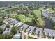 Aerial view of the community with a golf course, serene ponds, and well-maintained landscaping at 7724 Palm Aire Ln, Sarasota, FL 34243