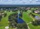 Panoramic aerial view highlighting the golf course, lush trees and serene ponds at 7724 Palm Aire Ln, Sarasota, FL 34243