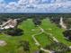 Expansive aerial view of the golf course, showcasing its lush green fairways and landscaped surroundings at 7724 Palm Aire Ln, Sarasota, FL 34243
