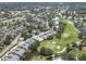 Aerial view showcasing the community's serene setting with lush greenery and a nearby golf course at 7724 Palm Aire Ln, Sarasota, FL 34243
