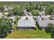 Aerial view of the property showing lush landscaping, a well-maintained roof, and surrounding neighborhood at 7724 Palm Aire Ln, Sarasota, FL 34243