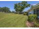 Expansive backyard featuring well-maintained lawn and mature landscaping, creating a serene outdoor space at 7724 Palm Aire Ln, Sarasota, FL 34243