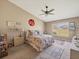 A spacious bedroom with a ceiling fan and plenty of natural light from a large window at 7724 Palm Aire Ln, Sarasota, FL 34243