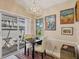 The dining area features a square table for four with a modern chandelier at 7724 Palm Aire Ln, Sarasota, FL 34243
