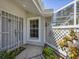 Welcoming entryway with decorative security door and view of the enclosed lanai at 7724 Palm Aire Ln, Sarasota, FL 34243