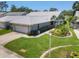 Charming single-story home with well-manicured lawn and attached two-car garage at 7724 Palm Aire Ln, Sarasota, FL 34243