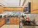 Bright kitchen showcases stainless steel appliances, granite countertops, and light wood cabinets at 7724 Palm Aire Ln, Sarasota, FL 34243