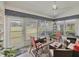 Enclosed lanai with comfortable seating, neutral tile flooring, and views of the landscaped backyard at 7724 Palm Aire Ln, Sarasota, FL 34243