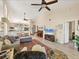 Open concept living room featuring vaulted ceilings, wood-look floors and comfortable seating at 7724 Palm Aire Ln, Sarasota, FL 34243