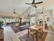 A comfortable living room features vaulted ceilings, a ceiling fan, and hardwood floors at 7724 Palm Aire Ln, Sarasota, FL 34243