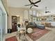 Open concept living room featuring vaulted ceilings, wood-look floors and comfortable seating at 7724 Palm Aire Ln, Sarasota, FL 34243