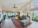 Bright living room featuring vaulted ceilings, wood-look floors and comfortable seating at 7724 Palm Aire Ln, Sarasota, FL 34243
