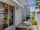 A private patio with outdoor seating features a small table and a sliding door at 7724 Palm Aire Ln, Sarasota, FL 34243
