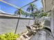 A private outdoor patio with seating set next to a sliding glass door at 7724 Palm Aire Ln, Sarasota, FL 34243