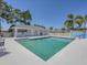 Community pool surrounded by lounge chairs, set in a well-maintained recreational space for residents to enjoy at 7724 Palm Aire Ln, Sarasota, FL 34243