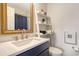 Stylish bathroom with modern fixtures, ladder shelving, and blue shower curtain at 9008 White Sage Loop # 3605, Lakewood Ranch, FL 34202