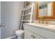 Clean bathroom with a white vanity, gold fixtures, and ladder-style towel rack at 9008 White Sage Loop # 3605, Lakewood Ranch, FL 34202
