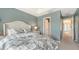 Comfortable bedroom features a floral-patterned bedspread and access to the hall at 9008 White Sage Loop # 3605, Lakewood Ranch, FL 34202