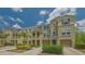 Inviting multi-unit building showcasing well-maintained landscaping, spacious garages, and appealing architectural details at 9008 White Sage Loop # 3605, Lakewood Ranch, FL 34202