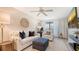 Bright living room featuring white furniture, neutral tones, and a ceiling fan at 9008 White Sage Loop # 3605, Lakewood Ranch, FL 34202