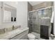 Bathroom features marble vanity, toilet and tiled walk-in shower with clear glass door at 9101 Yarberry St, Sarasota, FL 34240