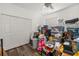 Bedroom with laminate floors is cluttered with boxes, bins, and other items at 9101 Yarberry St, Sarasota, FL 34240